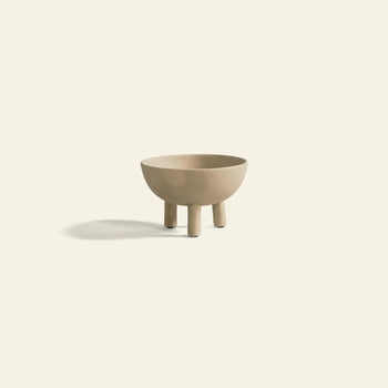 The 101 Copenhagen Duck Bowl, Big by 101 Copenhagen is a beige ceramic bowl with three cylindrical legs and Scandinavian-inspired design, shown on a light background with a soft shadow to the left.