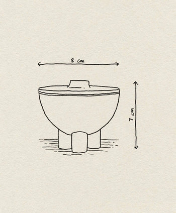 A simple line drawing of the 101 Copenhagen Duck Jar, Mini by 101 Copenhagen, featuring a bowl with three short legs (8 cm wide, 7 cm tall) and dimension arrows. The background is a light beige textured surface.