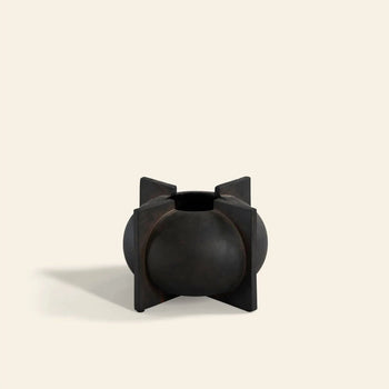 The 101 Copenhagen Kyoto Vase, Mini by 101 Copenhagen is a small, round, dark-toned ceramic vase with four flat rectangular panels, hand-glazed and displayed on a plain light beige background.