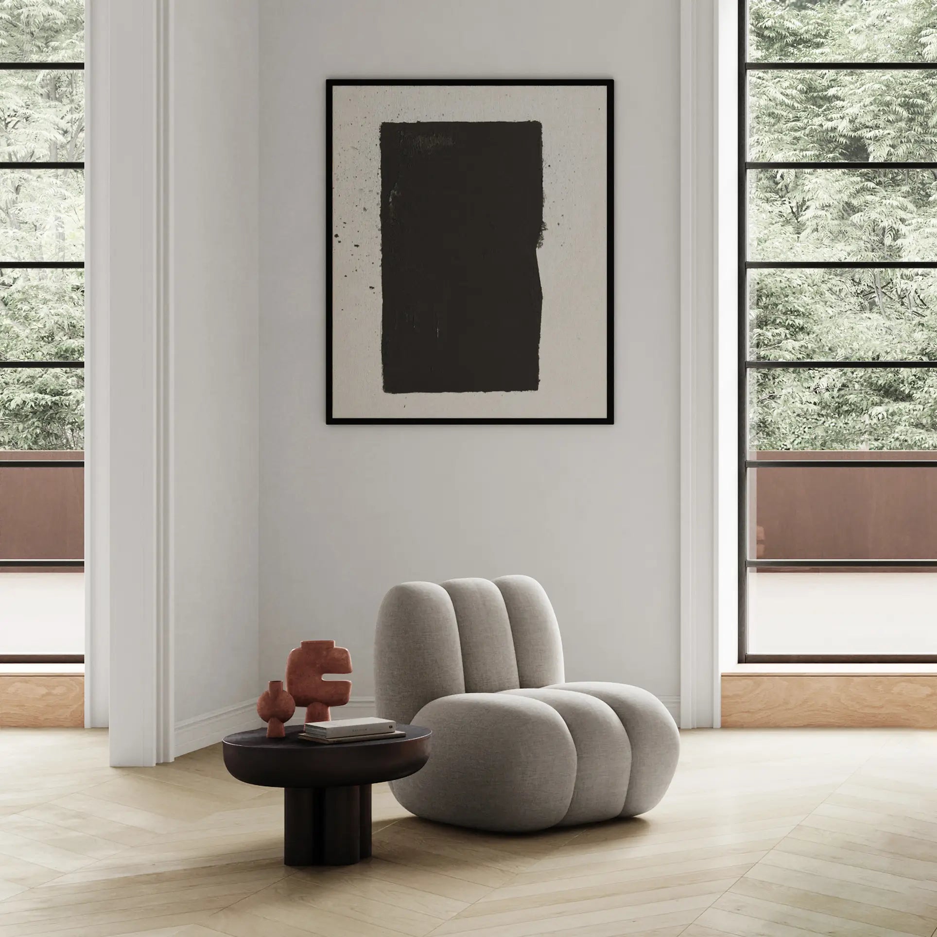Minimalist interior with a plush light gray lounge chair, round wooden side table featuring the 101 Copenhagen Tribal Vase, Mini by 101 Copenhagen, large windows, and a black-and-white abstract painting on the wall.