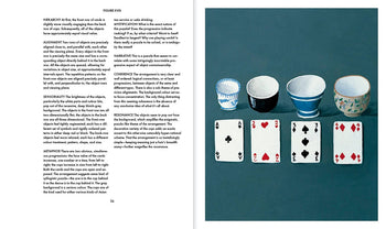 A two-page spread from Apartamento Arranging Things: A Rhetoric of Object Placement by Apartamento displays text on the left and, on the right, four teacups and four playing cards neatly arranged in two rows on a dark surface.