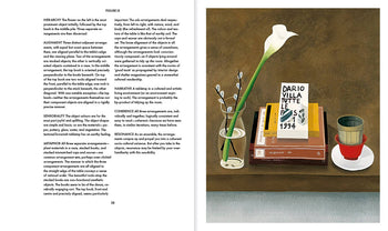 An open book, Apartamento Arranging Things: A Rhetoric of Object Placement by Apartamento, shows sectioned text on the left and an illustration on the right with a vase, books, framed card, and red cup arranged on a brown surface.