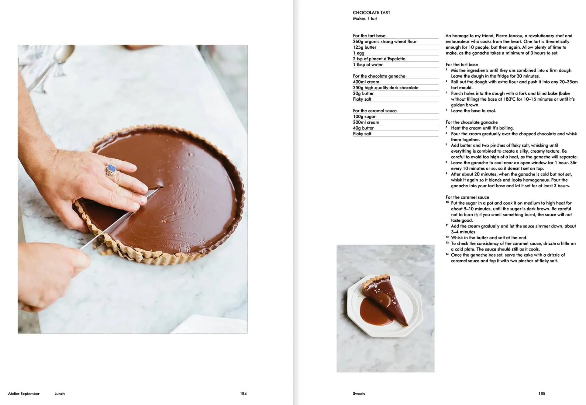 A person cuts a chocolate tart in a fluted pan. On the right is a recipe from Apartamento Atelier September: A Place for Daytime Cooking by Apartamento, with a photo of one tart slice on a plate next to a fork.