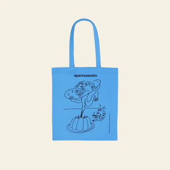 The Apartamento Cookbook #8 Tote Bag by Apartamento features a blue design with playful black line art—a person eating jelly and a surprised cat—ideal for fans of art, food, and eco-friendly style.