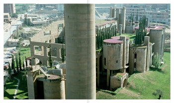 Apartamento’s La Fábrica by Ricardo Bofill features a large abandoned cement factory with cylindrical towers and overgrown vegetation, showcasing striking industrial reuse within the urban landscape.