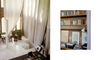 Inspired by Apartamento La Fábrica, Ricardo Bofill for Apartamento: a bright, airy space with sheer curtains and modern white furniture on the left; books and art prints on shelves embellish a textured wall to the right.