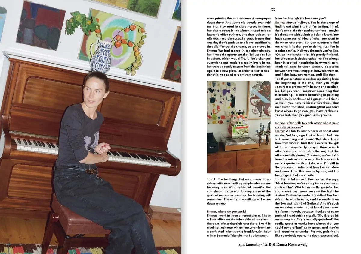 A woman sits on a bench by an upright piano, surrounded by abstract art inspired by Tal R. Beside her, an open Apartamento Magazine Issue #31 (Apartamento) displays a Spring Summer 2023 art feature and text column.