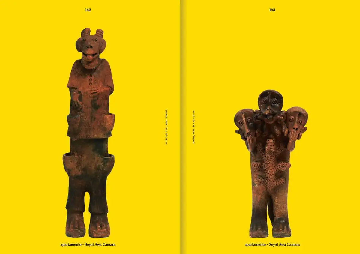 Two brown ancient-style figurines stand before a yellow backdrop, each with unique features—capturing the bold vibe of Apartamento Magazine Issue #31 by Apartamento. Black text appears at the top and bottom of the image.