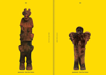 Two brown ancient-style figurines stand before a yellow backdrop, each with unique features—capturing the bold vibe of Apartamento Magazine Issue #31 by Apartamento. Black text appears at the top and bottom of the image.