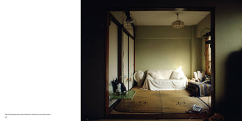 A compact Tokyo-style room inspired by Apartamento Tokyo Style, Kyoichi Tsuzuki from Apartamento, with tatami mats, a white sofa by a green wall, paper sliding doors, sunlight, a green table, decor accents, and a patterned blanket.