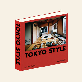 The Apartamento Tokyo Style book by Kyoichi Tsuzuki (Apartamento) displays a photo of a cluttered, traditional Japanese room on its red cover. The upright book shows both the spine and front cover.
