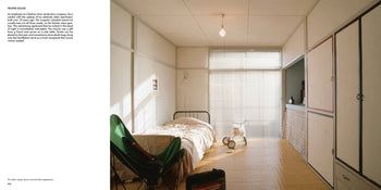 A minimalist bedroom inspired by Apartamento Tokyo Style by Kyoichi Tsuzuki features a single bed, bamboo floor, green folding chair, sunlight through large windows with blinds, built-in closets, plus a lamp, books, and suitcase beside the bed.