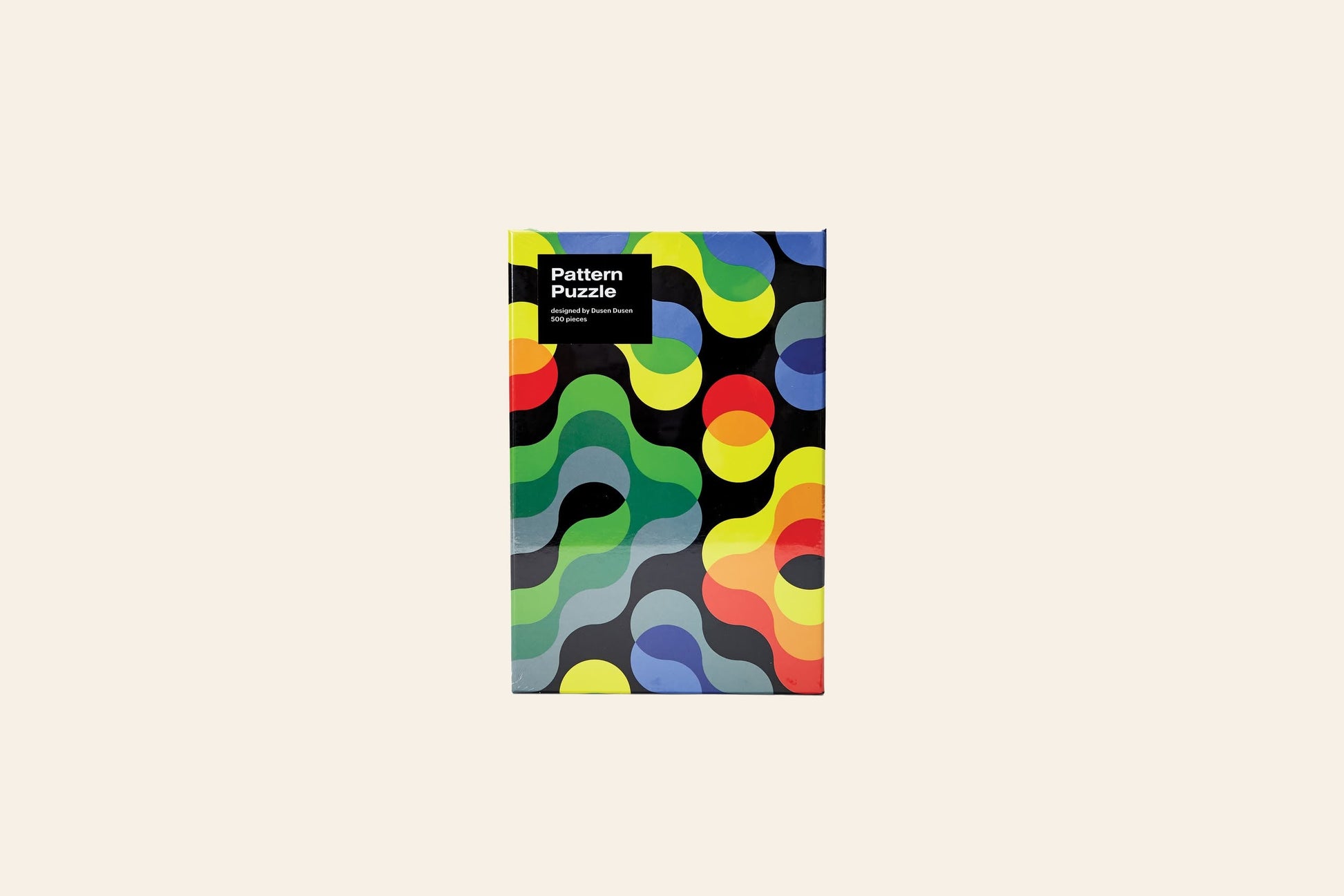 The Areaware Dusen Dusen - Pattern Puzzle by Areaware is a 500-piece jigsaw featuring a bold abstract design with wavy, interlocking shapes on a light beige background—ideal for design enthusiasts.