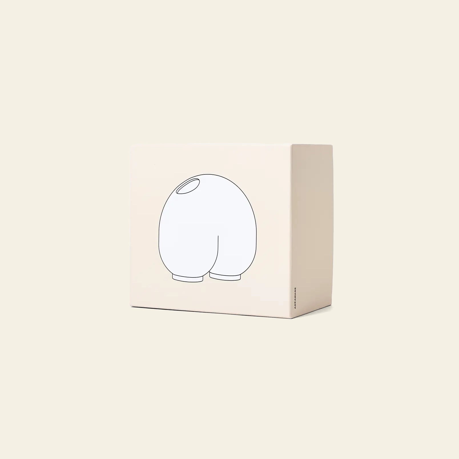 The Areaware Kirby Vase Enny by Areaware features a beige box with a simple black outline of its rounded, cartoonish form facing away, making it perfect for gifting with floral arrangements or pairing with your best bud vase.