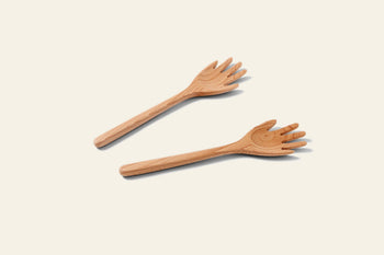 Areaware Serving Friends - Hands by Areaware are two wooden salad forks shaped like hands, featuring carved fingers and a thumb, that bring playful style to your dining table.