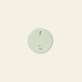 The Areaware Wall Clock by Areaware features a round, light green geometric design with a circular center and is shown against a plain beige background.