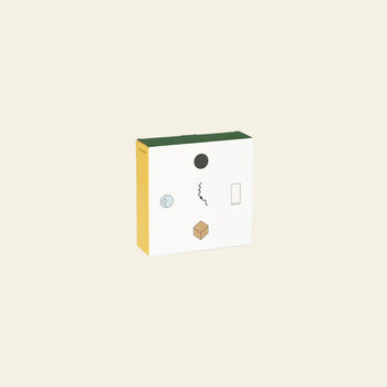 The Areaware Wall Clock by Areaware features a square, minimalist design with a green top, yellow side, and white front. Abstract black and light blue geometric shapes stand out on its beige background for a modern look.