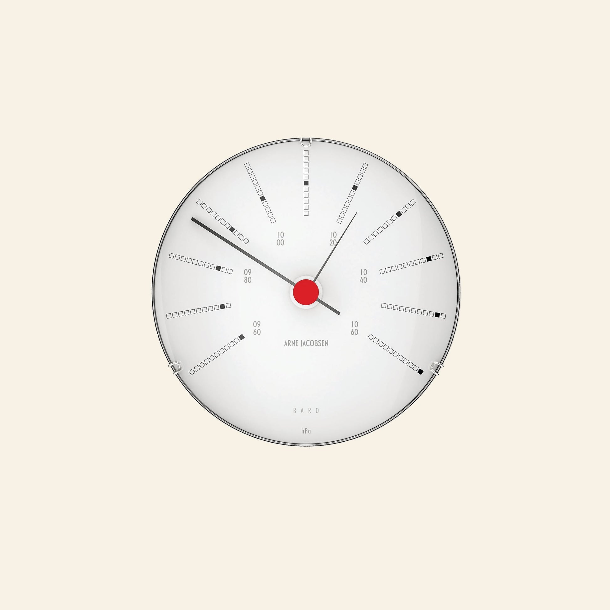 The Arne Jacobsen Bankers Barometer 12cm features a minimalist round design with a white face, black markings, red center, and three black hands to display atmospheric pressure in a clean, numbered layout with rectangular indicators.