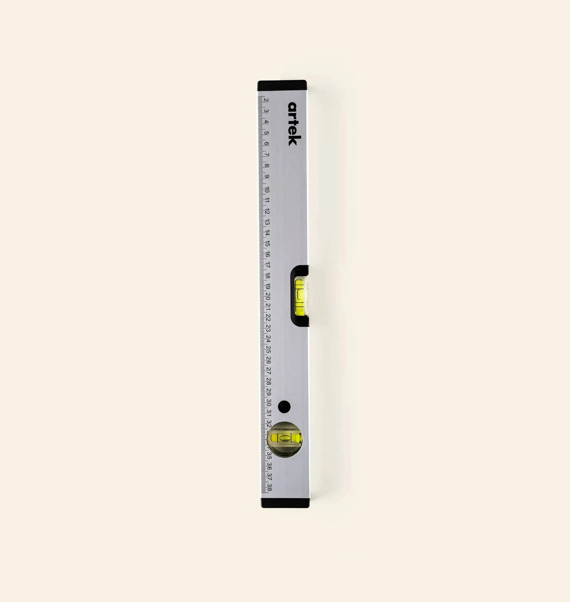 The Artek Level by Artek is a silver aluminum tool with a built-in ruler, marked measurements, and two yellow bubble vials for accurate alignment—an essential addition to your toolkit.