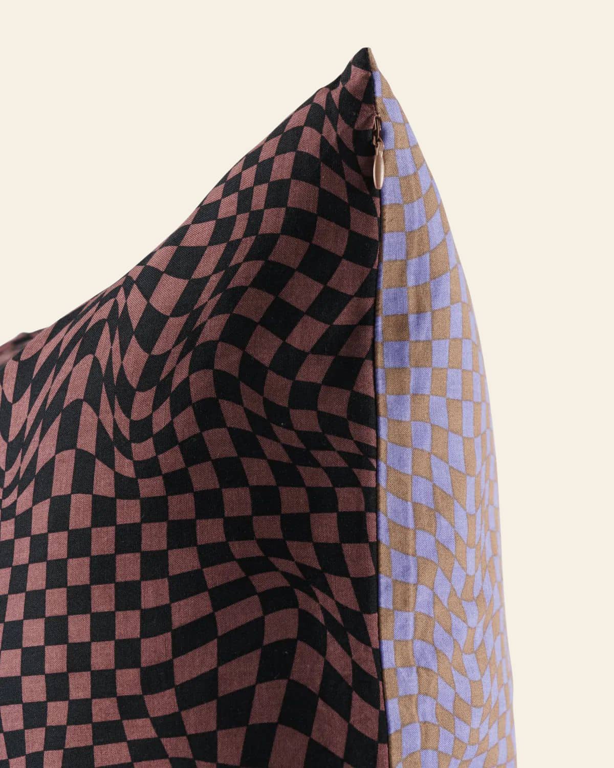 Close-up of the BAGGU Throw Pillow Case by BAGGU, featuring a trippy checker design—wavy black and brown checks on one side, black and lavender checks on the other—perfect for adding flair to your living space.