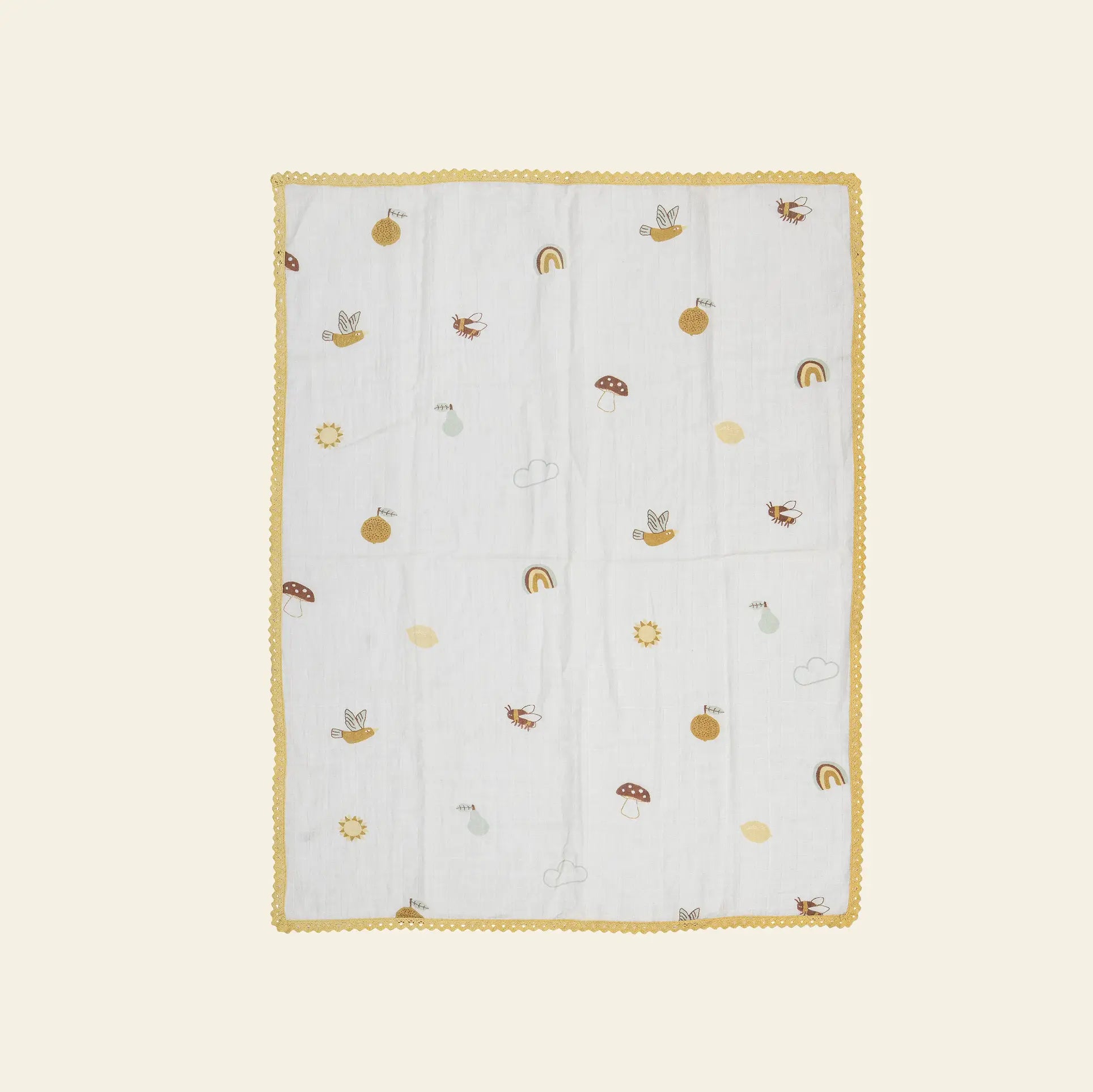The Bloomingville Agnes Blanket by Bloomingville is a white muslin baby blanket with a yellow scalloped border and small prints of rainbows, suns, mushrooms, clouds, and animals on a light background.
