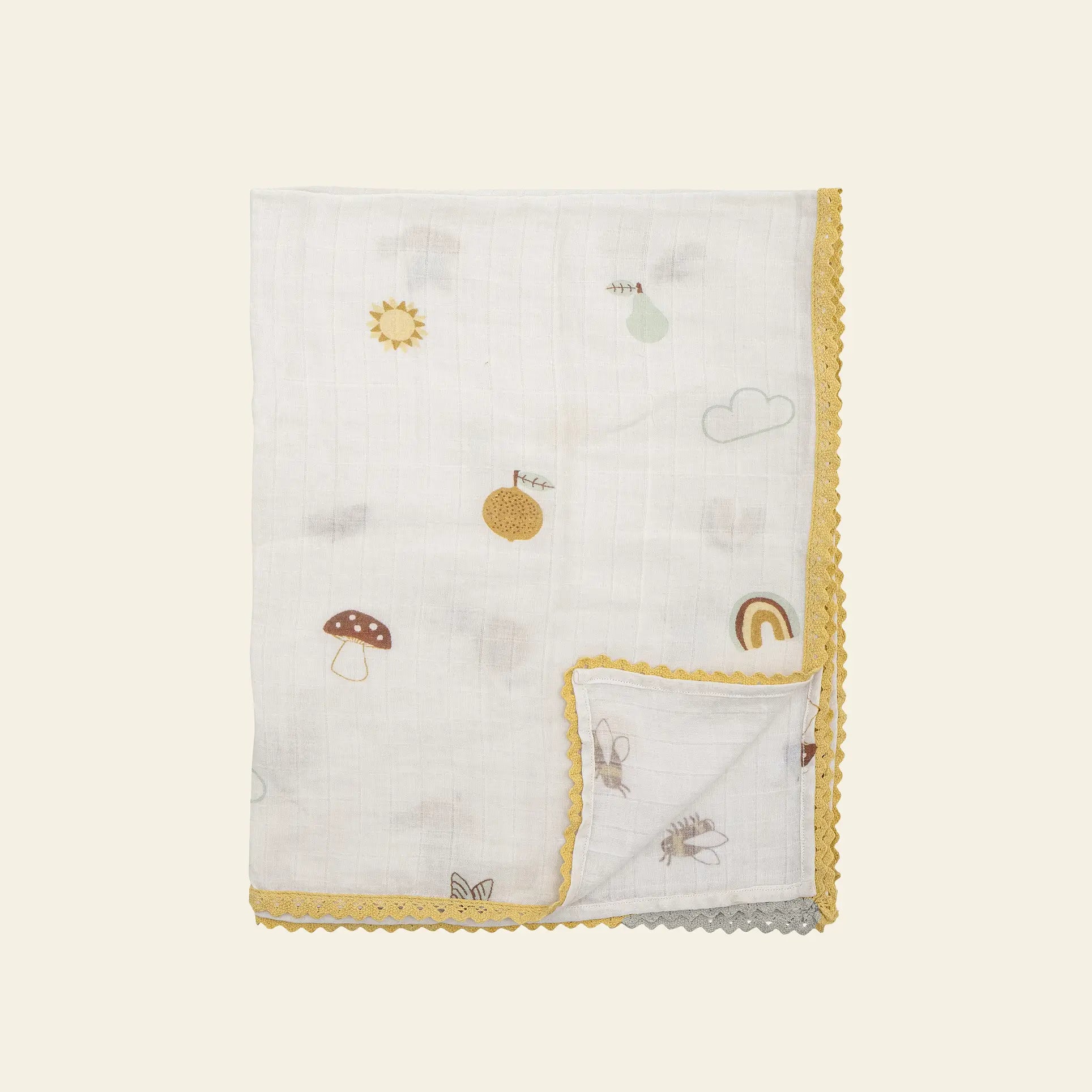 The Bloomingville Agnes Blanket by Bloomingville is a white muslin baby blanket featuring yellow scalloped edges and playful pastel patterns of mushrooms, bees, rainbows, clouds, suns, and fruit.