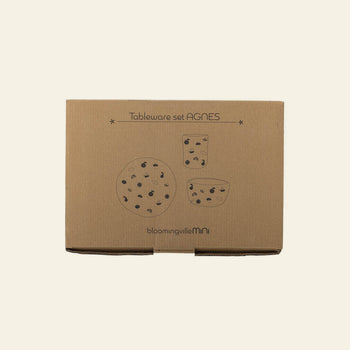 A brown cardboard box labeled Bloomingville Agnes Tableware Set features simple black illustrations of three polka dot tableware pieces, with the Bloomingville brand printed at the bottom.