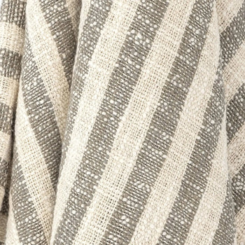 Close-up of the Bloomingville Binnur Throw by Bloomingville, showcasing woven cotton fabric with alternating beige and gray vertical stripes, a subtle texture, and minimalist style.