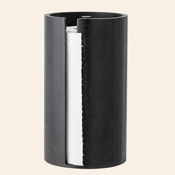 The Bloomingville Celian Kitchen Paper Stand features a sleek black cylindrical design with a vertical cutout, revealing the roll inside—a minimalist accessory from Bloomingville that brings Scandinavian elegance to any space.
