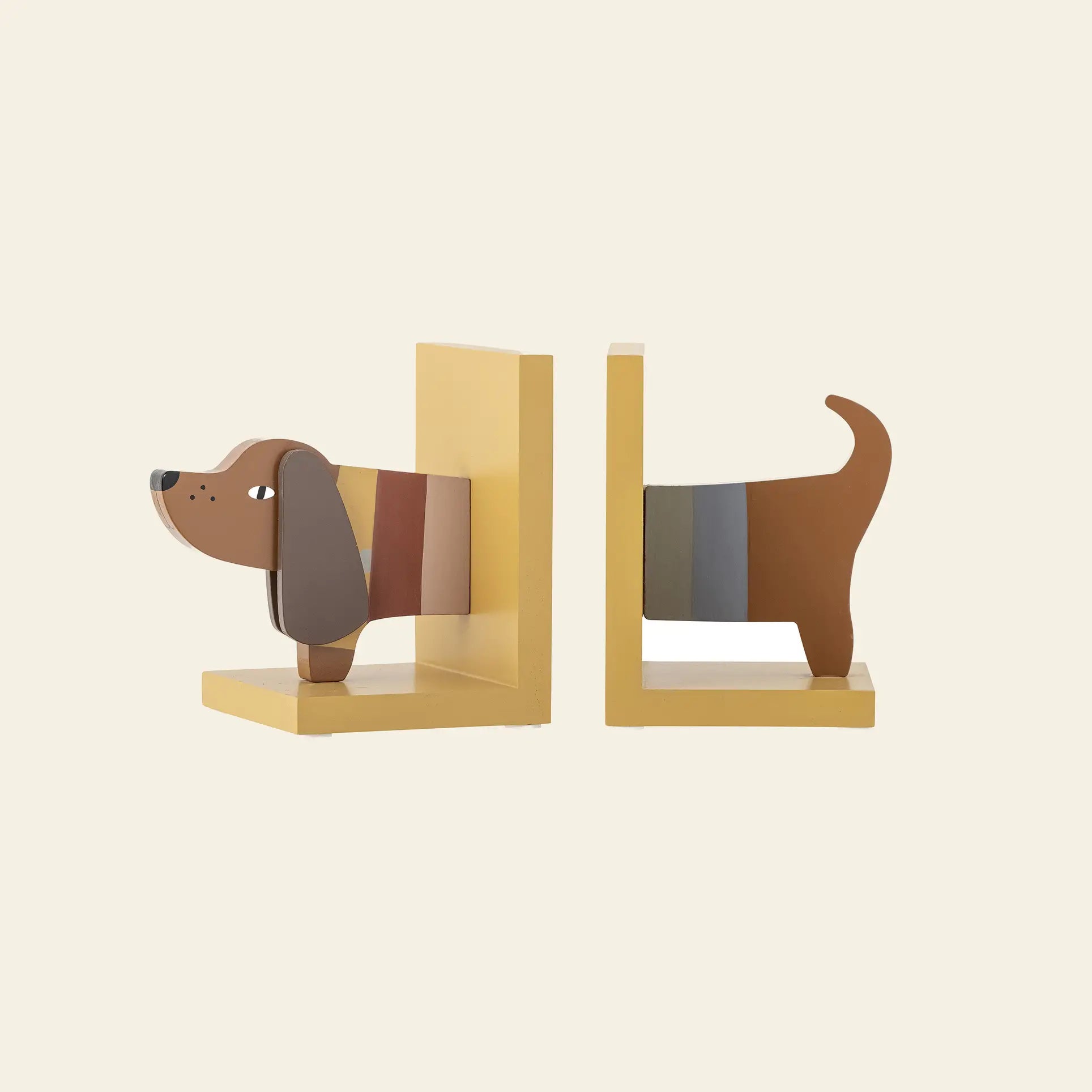 The Bloomingville Charlie Bookend by Bloomingville features two yellow pieces forming the front and back of a stylized brown dog with floppy ears, tail, and colorful stripes—fun childrens room accessories made from FSC-certified wood.