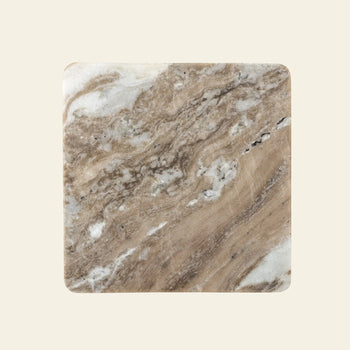 The Bloomingville Gabrielle Trivet by Bloomingville is a square marble trivet with natural stone texture, showcasing brown, beige, and white swirls on a cream background. Slightly rounded corners add style while protecting your table.