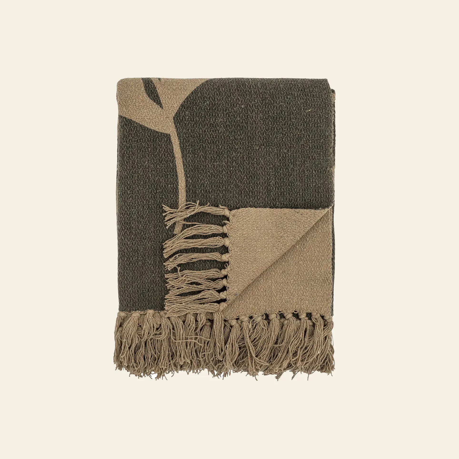 The Bloomingville Geneva Throw by Bloomingville is a folded, fringed throw made from recycled cotton in dark green and beige, featuring a minimal two-tone leaf green pattern—perfect for adding cozy decor to any room.