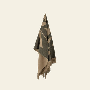 The Bloomingville Geneva Throw by Bloomingville, featuring a tan and dark green pattern with fringed edges, is crafted from recycled cotton and displayed against a neutral background.
