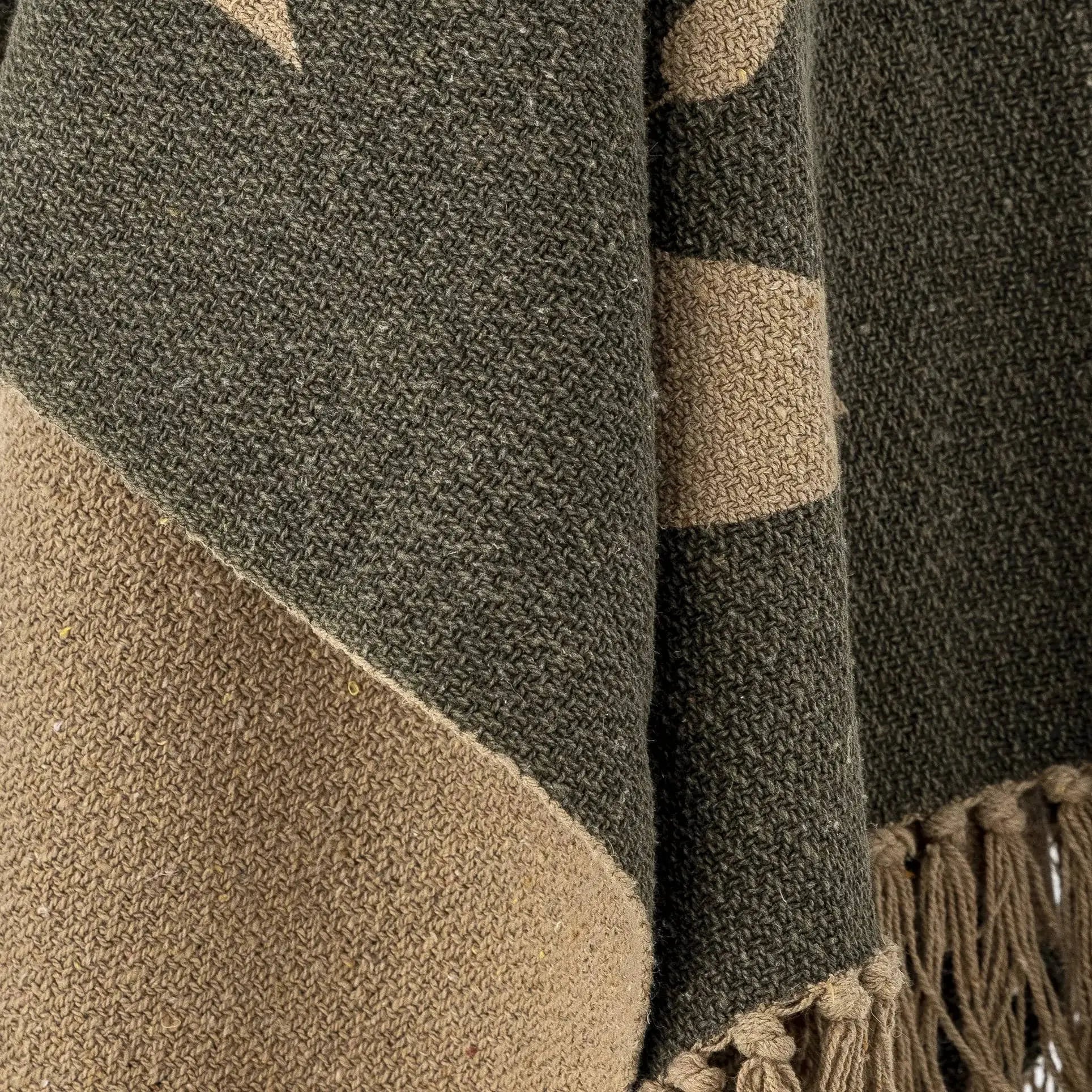 The Bloomingville Geneva Throw by Bloomingville features recycled cotton, a green geometric pattern with beige tones, and fringed edges with tassels—ideal for adding cozy style to your home décor.