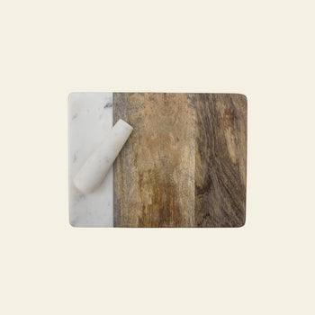 The Bloomingville Havannah Cutting Board w/Pestle by Bloomingville features three sections—white marble, mango wood, and dark wood—with a white marble pestle resting diagonally on the marble section against a light background.
