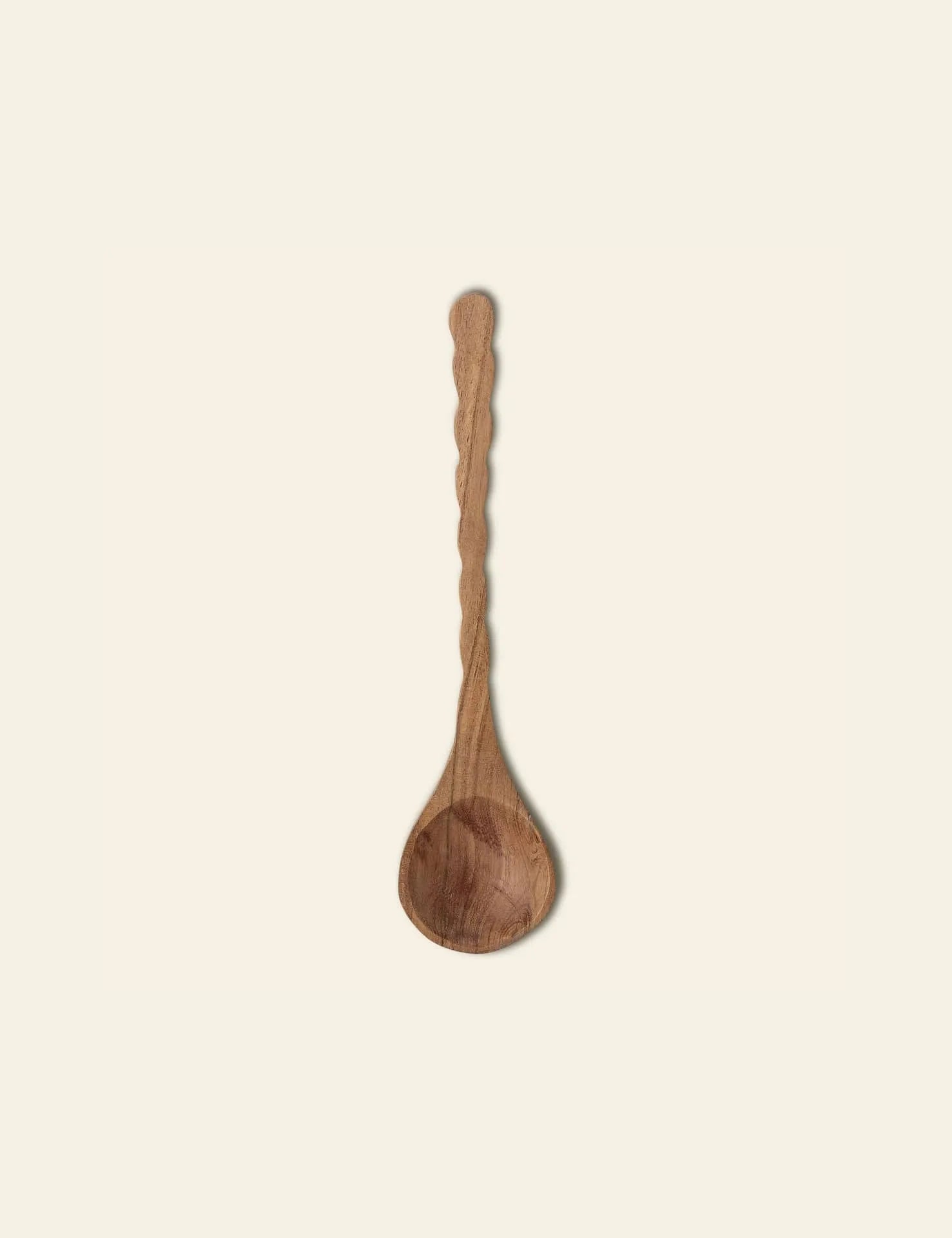 The Bloomingville Ivy Spoon by Bloomingville features a carved, textured wooden handle and rounded bowl, crafted from natural wood and shown on a plain, light background.