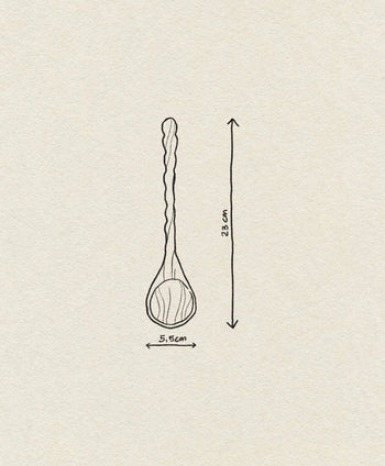 The Bloomingville Ivy Spoon by Bloomingville features a simple line drawing of its twisted handle, measuring 23 cm long and 5.5 cm wide at the bowl, displayed on textured paper—an elegant kitchen accessory.