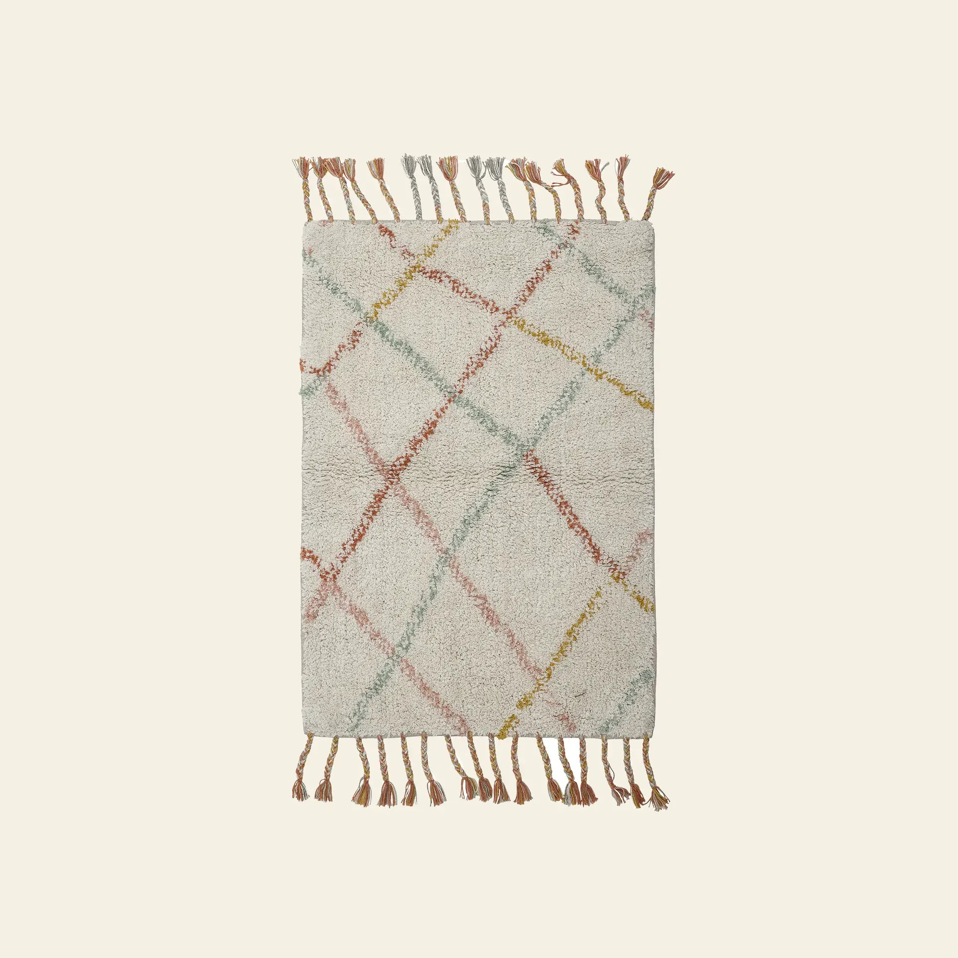 The Bloomingville Lilou Rug by Bloomingville is a rectangular childrens rug with a cream background, intersecting pastel green, orange, and yellow lines, and playful tassels on both shorter sides.