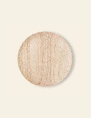 The Bloomingville Nolia Plate, 25cm, features a light tone, smooth texture, and rustic finish; it’s ideal for serving comfort foods and stands out against a plain off-white background.