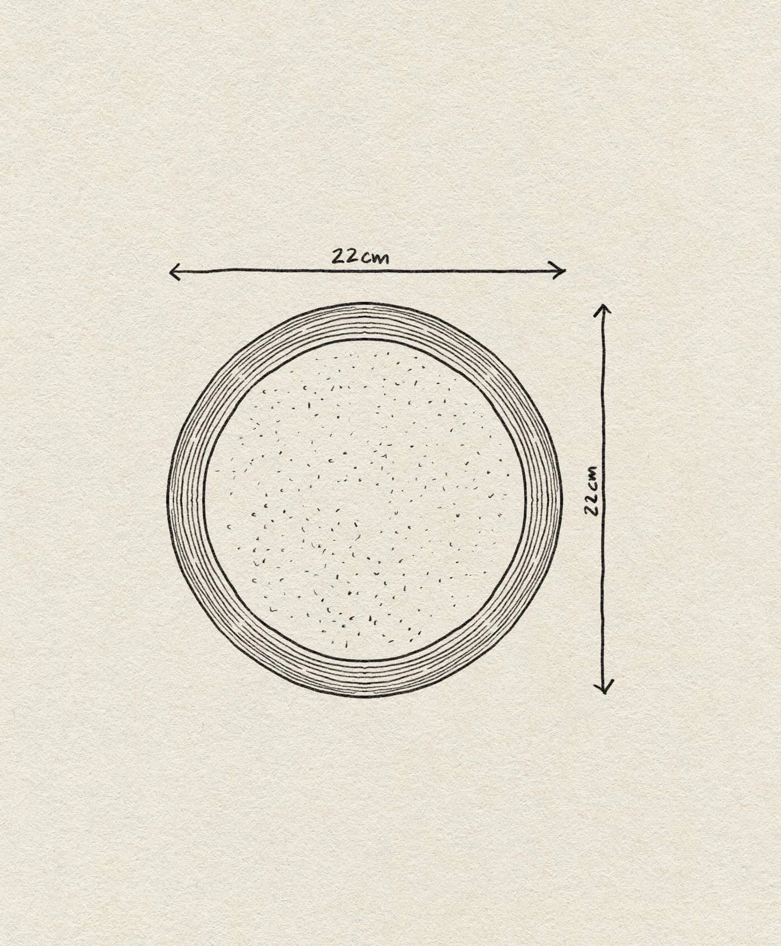 A hand-drawn illustration of the Bloomingville Nugga Plate, a 22 cm stoneware plate by Bloomingville, shown from above with labeled measurements on light textured paper, evoking an inviting outdoor meal setting.
