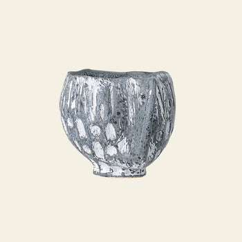 The Bloomingville Oney Flowerpot by Bloomingville is a small, round ceramic piece with a textured, grayish-white glaze and abstract raised patterns—its unique shape makes it perfect as a decorative flowerpot cover.