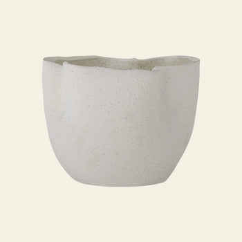 The Bloomingville Sanam Flowerpot by Bloomingville is a contemporary white, speckled stoneware flowerpot with an uneven, organic rim and a matte finish, set against a plain beige background.