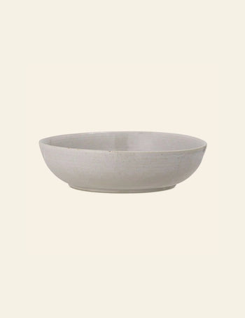 The Bloomingville Taupe Serving Bowl by Bloomingville is a shallow, round ceramic bowl with a matte, light grey natural finish, displayed against a plain off-white background.