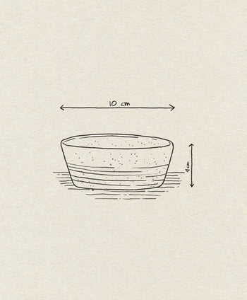 A minimalist sketch of the Bloomingville Taupe Snack Bowl shows horizontal shading lines and arrows noting its 10 cm diameter and 4 cm height, set on a beige textured background, with the Bloomingville brand labeled.