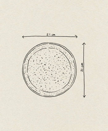 A line drawing of the Bloomingville Thea Plate, showing speckled stoneware details. Two arrows mark its 21 cm diameter across and down. The background is textured off-white.