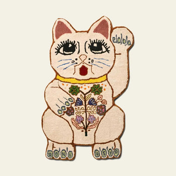 The Bongusta Lucky Rug by Bongusta is a hand-tufted wool rug shaped like a maneki-neko, with large eyes, raised paw, floral accents, and RING RING on its feet in soft pastels over a cream background.