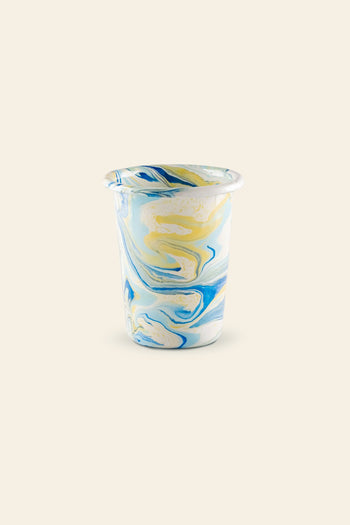 The Bornn Enamelware New Marble Tumbler Cup features a small glass design with a blue, yellow, and white marbled pattern, displayed against a plain beige background.