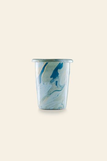 The Bornn Enamelware New Marble Tumbler Cup features a marbled blue, white, and tan design, shown against a beige background. Available at The Stacked Store.
