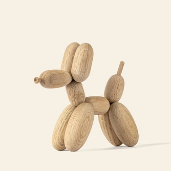 The Boyhood Ballon Dog Small by Boyhood is a whimsical sculpture made from smooth European FSC-certified oak, featuring four legs, a tail, and pointed nose—blending playful art with sustainable craftsmanship against a light background.