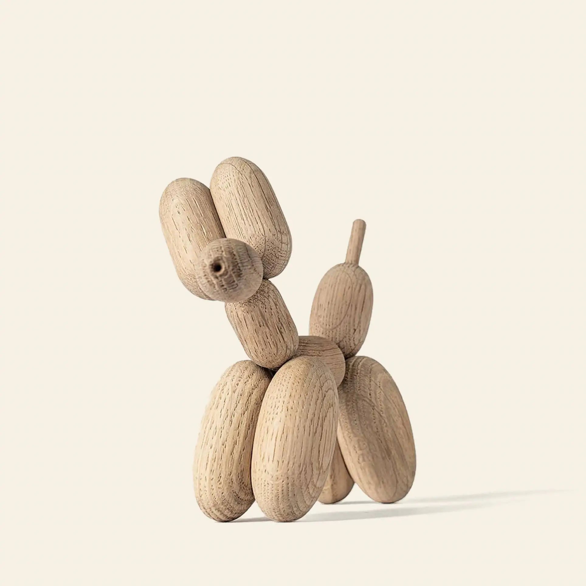 The Boyhood Ballon Dog Small by Boyhood, made from smooth European FSC certified oak, features rounded segments and sits on a neutral light background, blending whimsical fantasy with natural elegance.